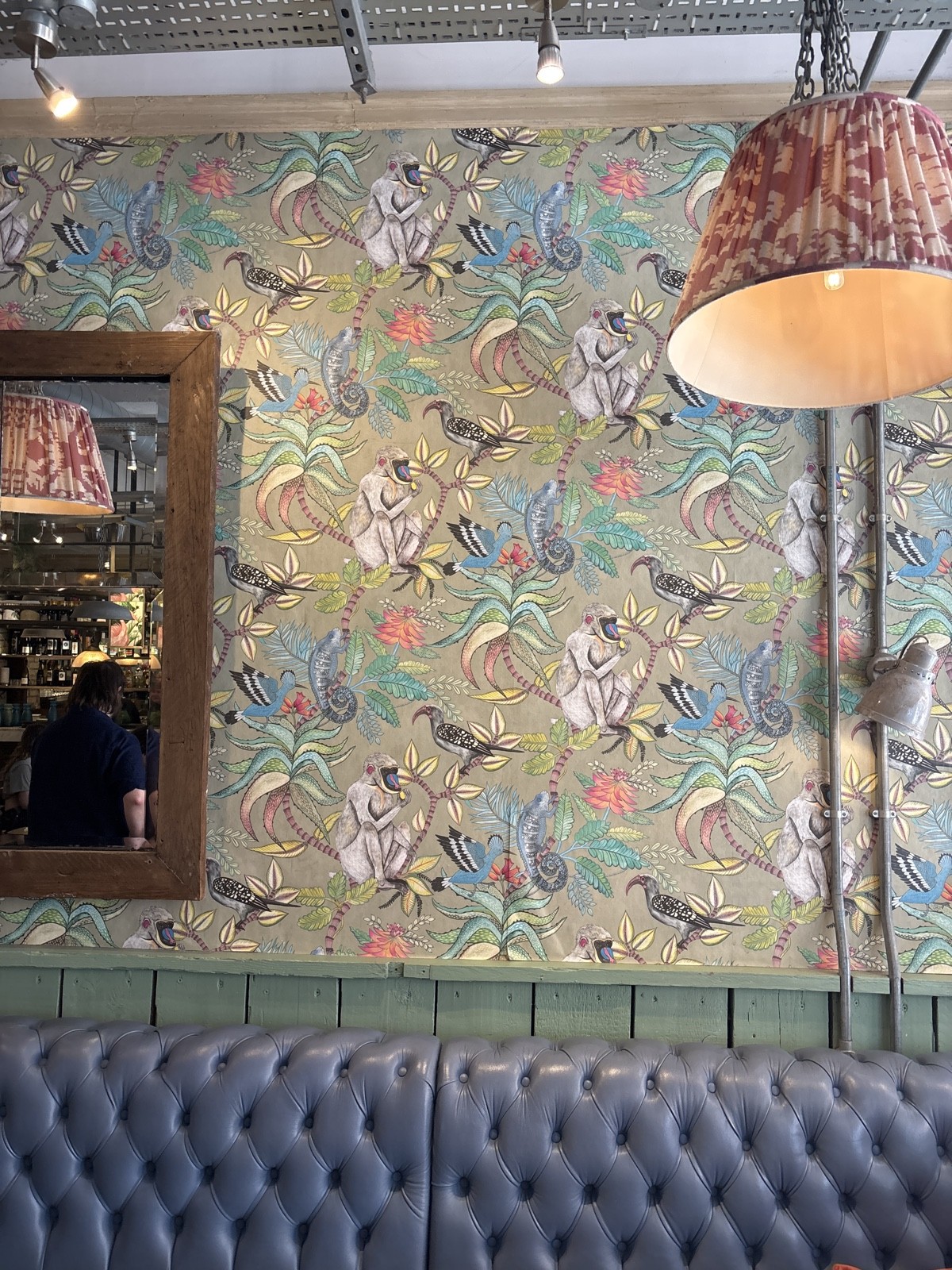 the photo shows very vibrant patterns on the wallpaper, and mirrors which are seen around the restaurant