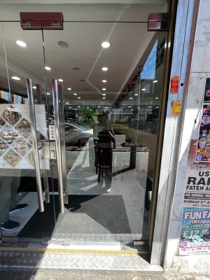 2 steps to glass door ahead. Push from silver handle on left to open.