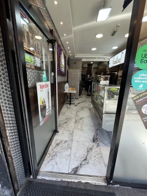 Single glass door. Push silver handle to open.