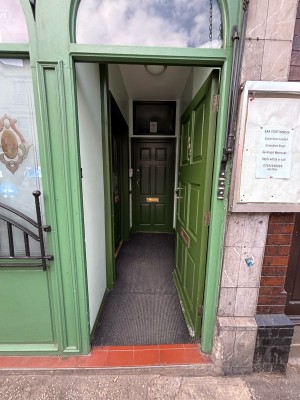 Green door ahead. Push from left to open.