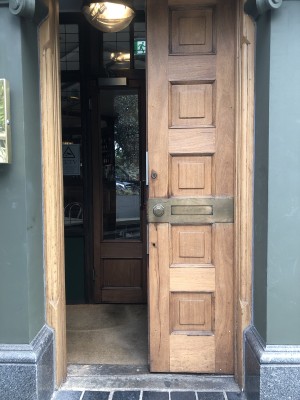 Brown wooden doors. Push handles in centre to open.