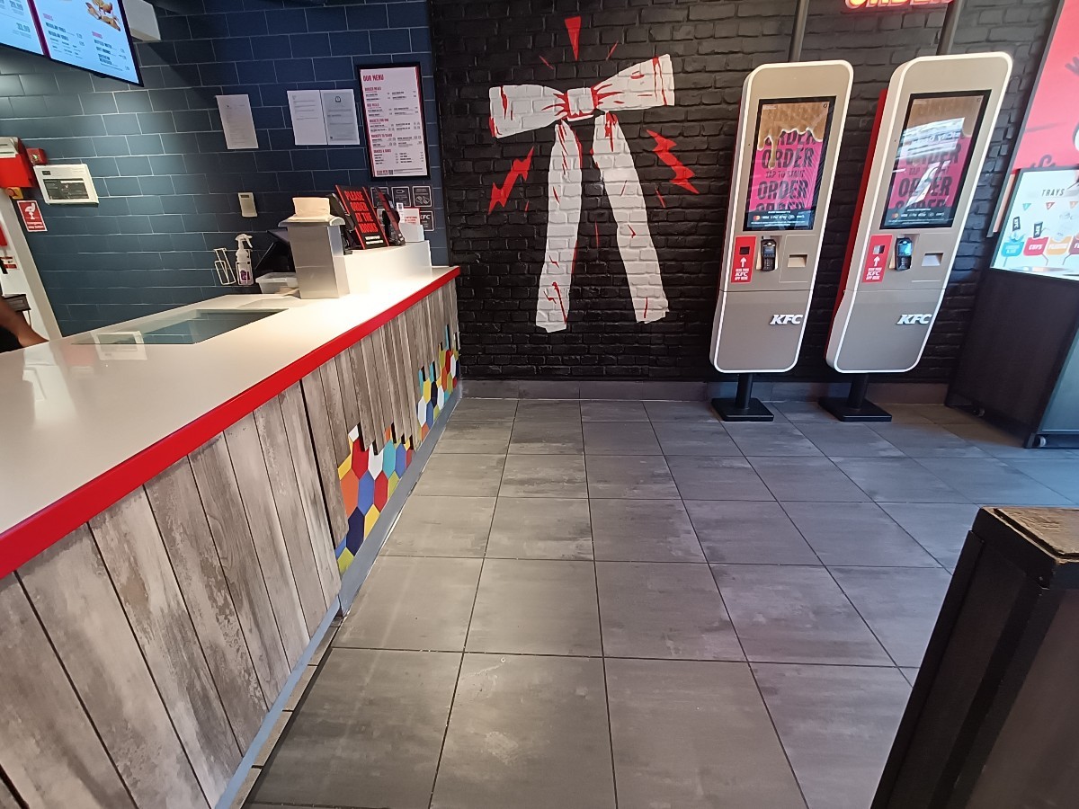 From counter, facing right. Counter along left. Ordering screens at the back right.
