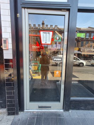 Grey framed glass door. Push from right to open.
