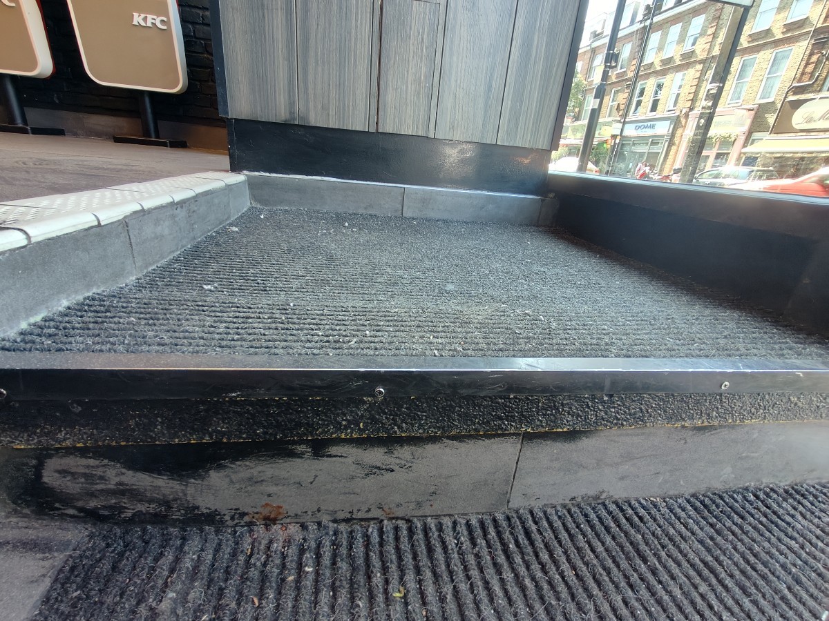 One step up on right of door followed by doormat.