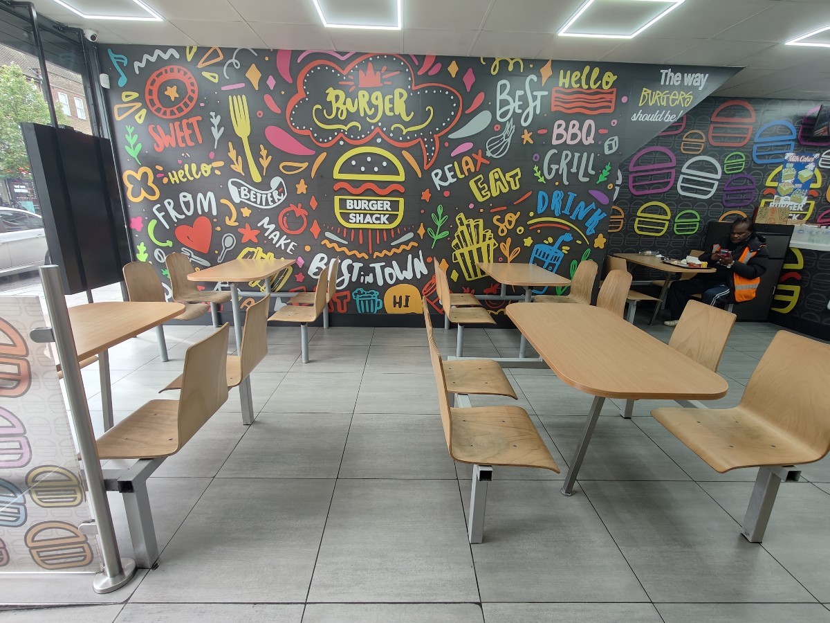 From entrance facing left. Rows of tables and chairs ahead.