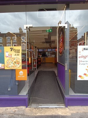 Glass door with silver handle on right. Push to open.