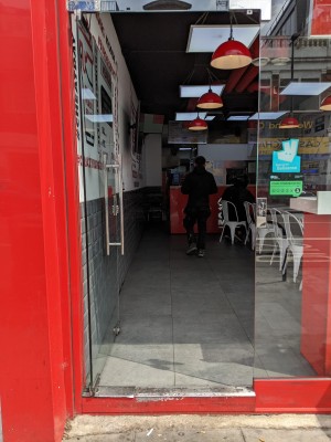 Glass door with metal handle on right. Push to open.
