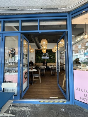 Glass doors with blue frame. Push handles in centre to open.