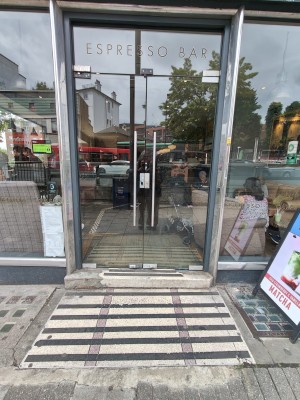 One step up to glass doors. Push silver handles in centre to open.