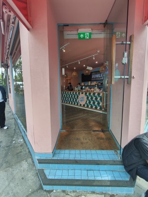 Two steps up to glass door. Pull silver handle on left to open.