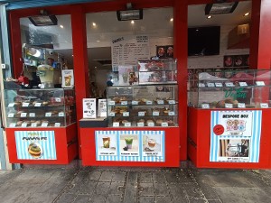 From street, facing venue. Counter and display along back.
