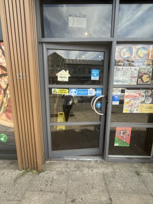 Single glass door with silver handle. Pull handle on right to open door.