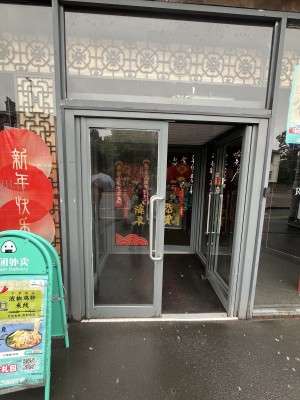 Preceding grey framed glass doors with silver handles. Push from handles at centre to open.