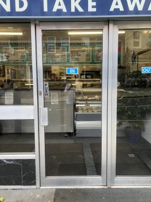 Silver framed glass door. Push silver handle on left to open.