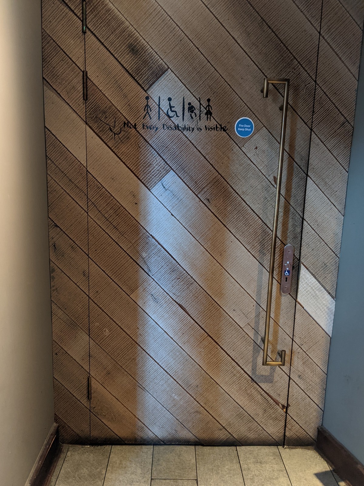 From before staircase facing left. Wood door with wood frame ahead. Pull from metal handle on right to open. Radar key hole right of handle.