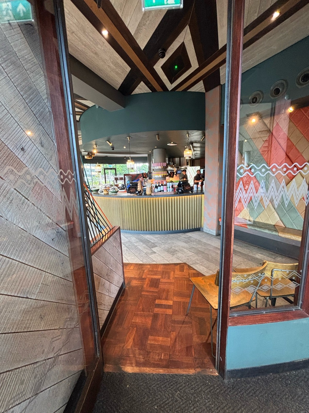 From left end of glass divider facing straight. Glass door ahead. Pull via handle on right to open.