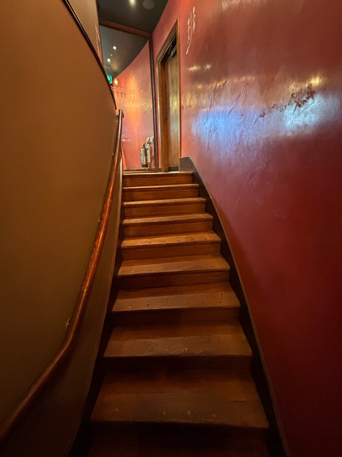 From landing facing straight. Staircase continues up ahead. Handrail along left.