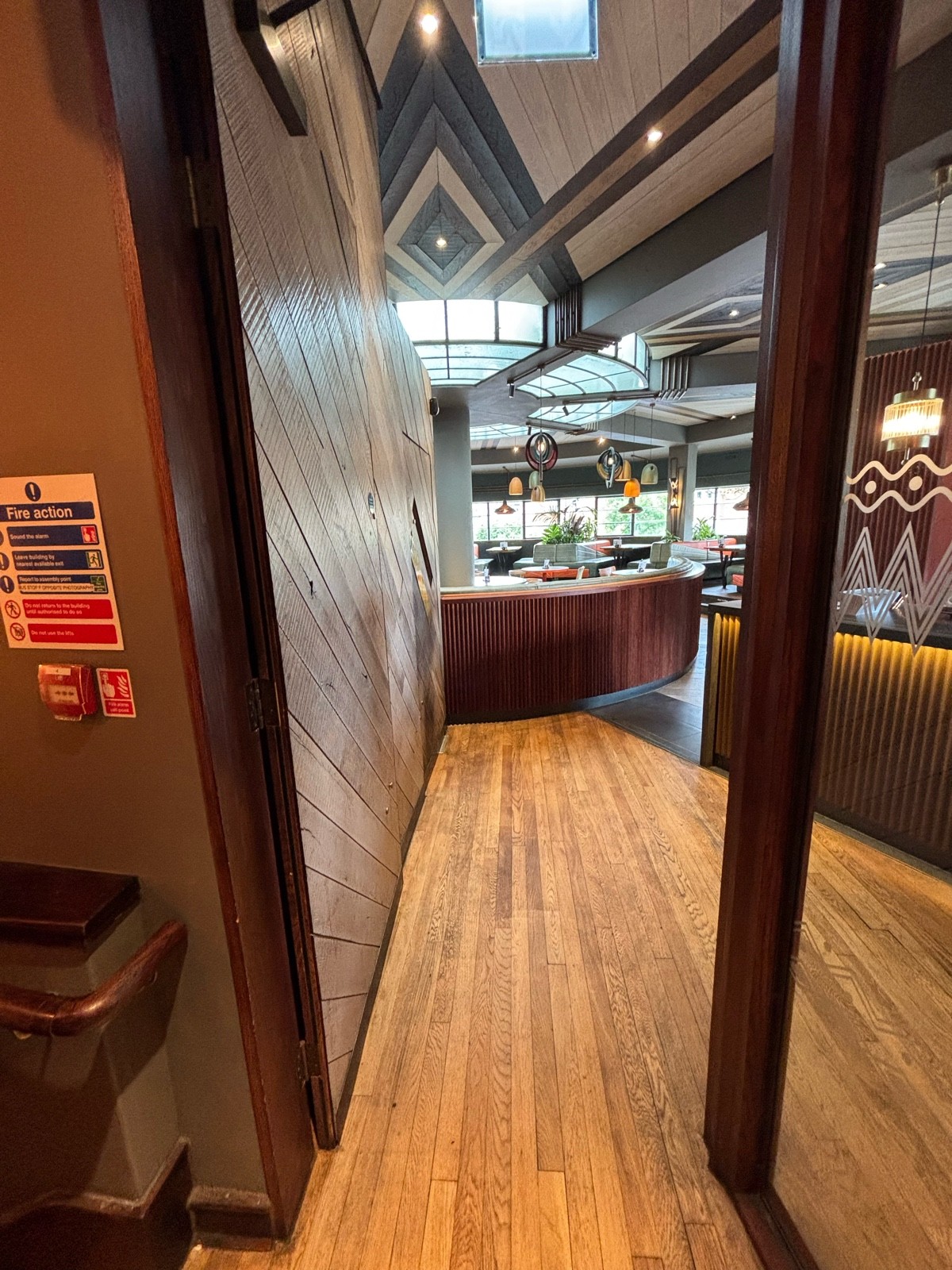 From top of stairs facing left. Wooden door ahead. Push from right to open.