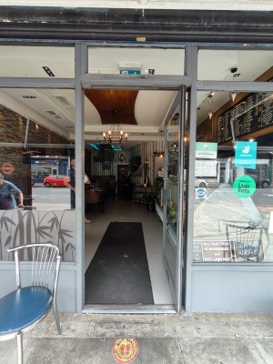 Grey framed glass door. Push grey handle on left to open.
