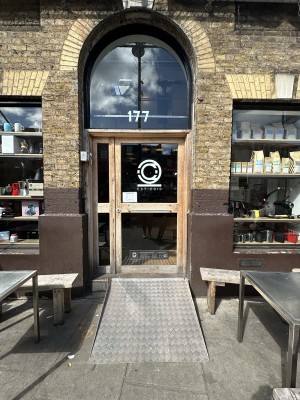 Glass doors with brown frame. Push handle from left to open.