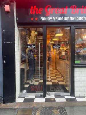 Two single glass doors ahead. Push or pull metal handle on either door from centre to open.