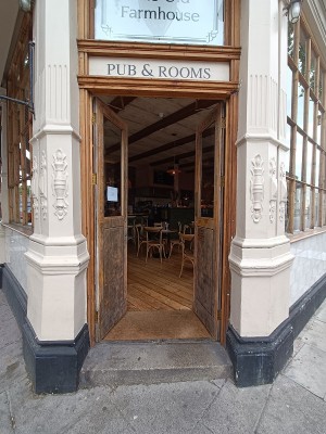 Glass door with brown, wooden doors ahead. Push from middle to open.