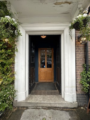 Black doors with white frame. Push from centre to open.