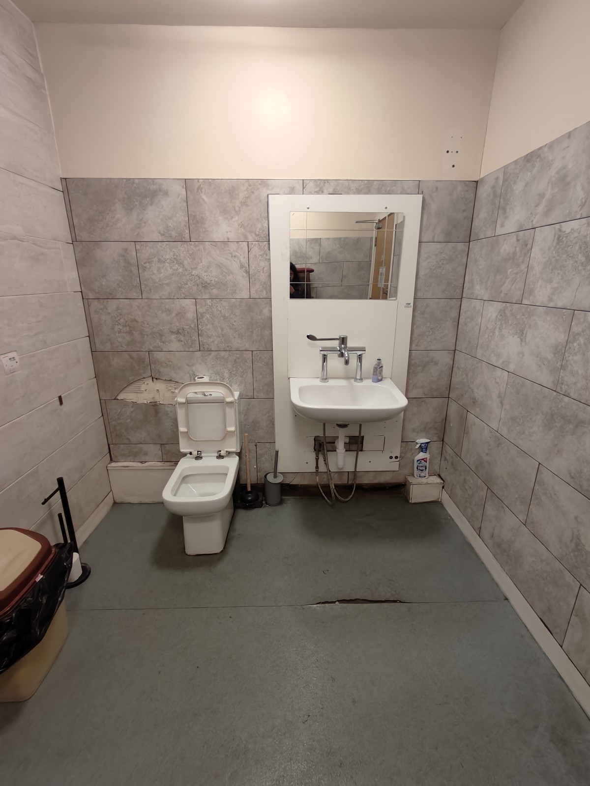 From storage facing right. Toilet at back left. Sink at back right.