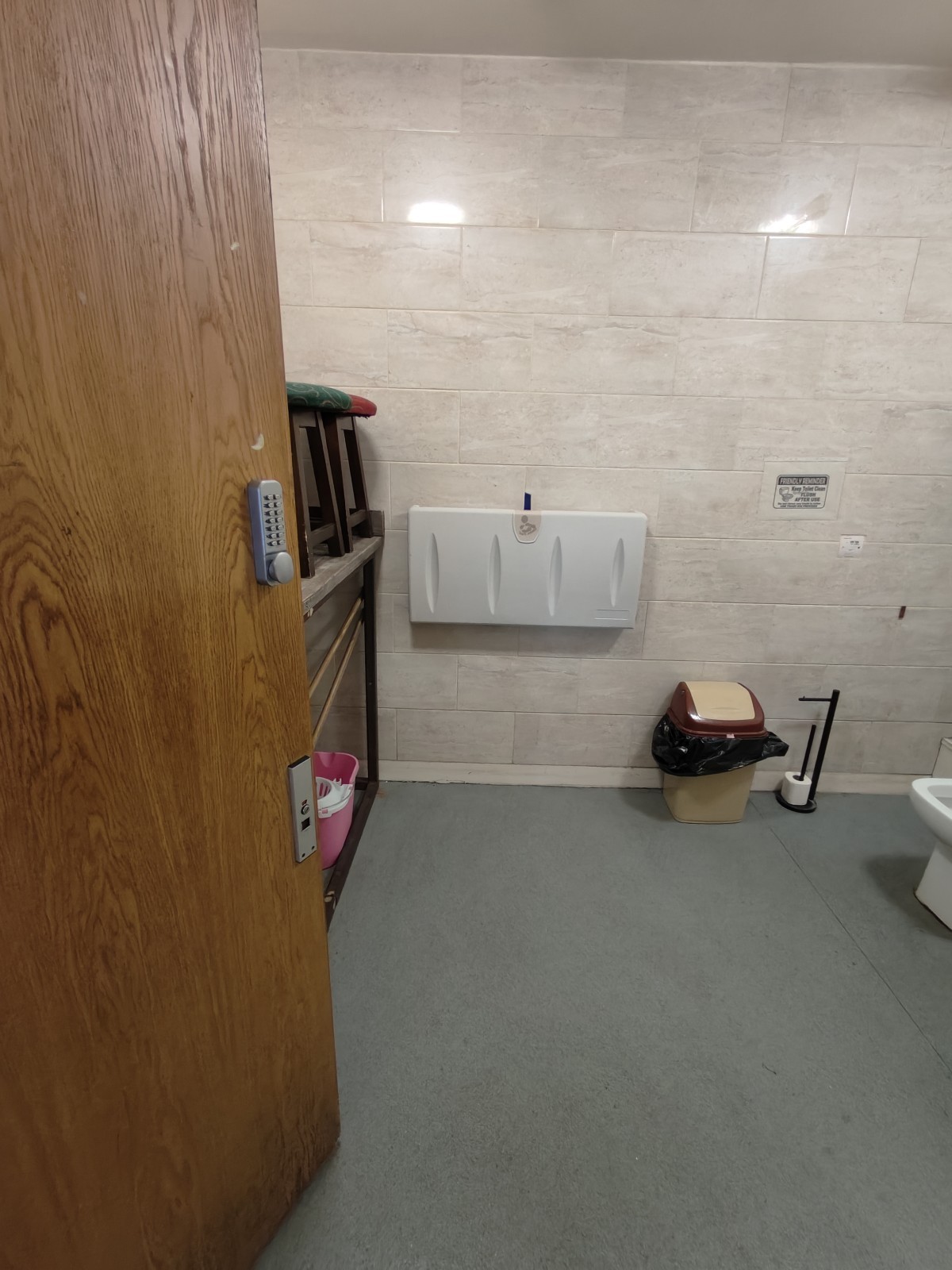 From door facing straight. Storage on left. Baby change table at back.