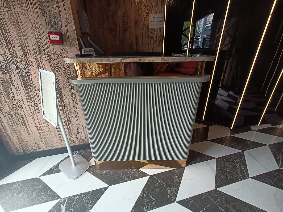 From entrance, facing left. Welcome desk ahead.