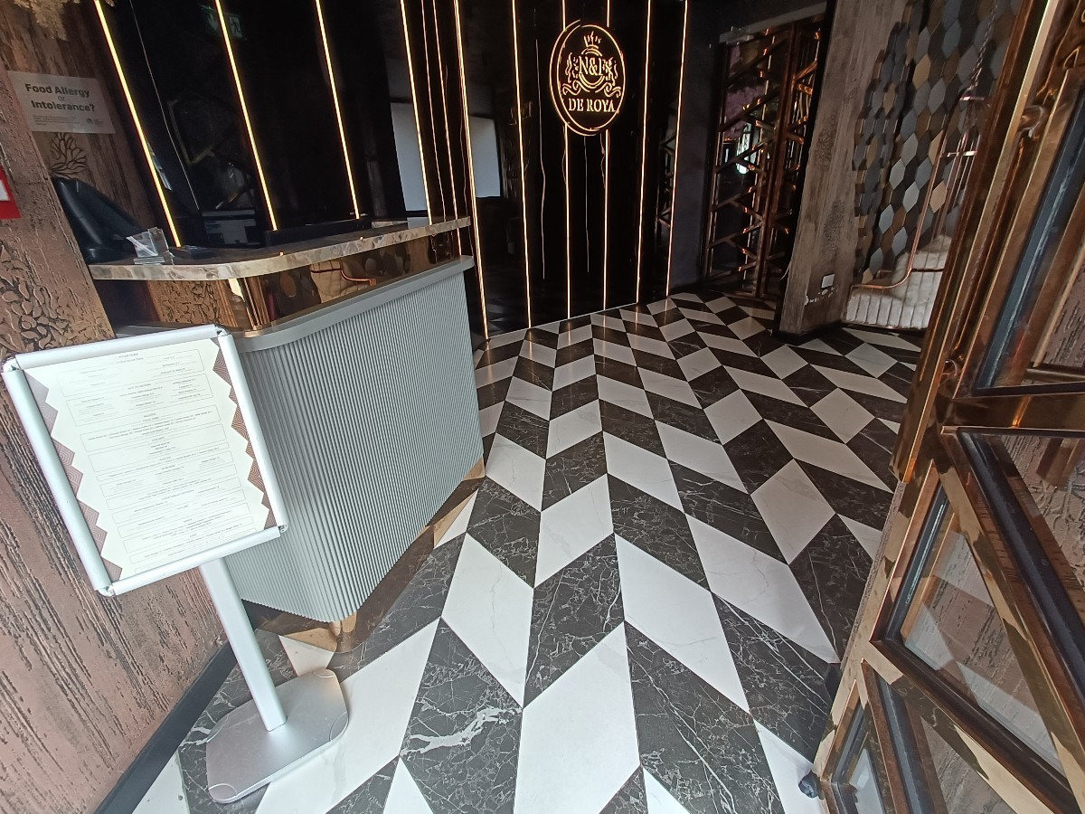 From doorway, facing straight. Welcome desk on left.