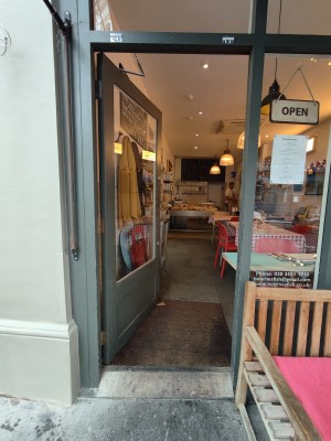 Grey framed glass door. Push from right to open.