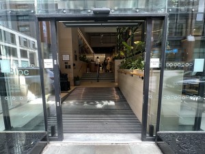 Black and glass panelled automatic door ahead.