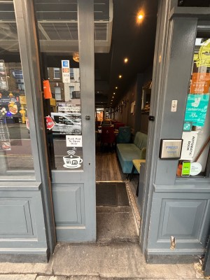 Glass door with grey frames. Slide from right to left to open.