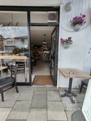 Black framed glass door. Push black handle on left to open.