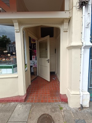 From street, facing venue. Archway ahead.