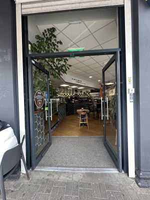 Glass doors with black frame. Push silver handles in centre to open.