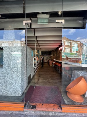 Glass door. Push silver handle from right to open.