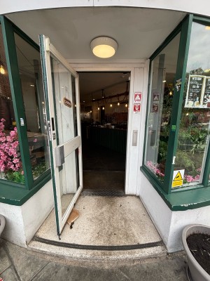 Glass door with white frames. Pull from right handle to open.