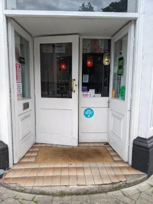 White doors with glass panels and white frames. Push from centre to open.