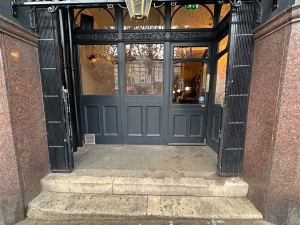 Black gates sliding from centre to open.