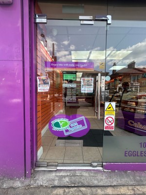 Glass door ahead. Push silver handle on right to open.