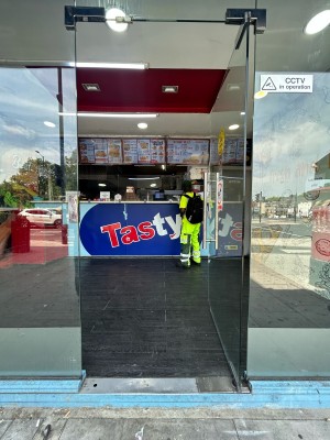 Glass door ahead. Push silver handle on left to open.