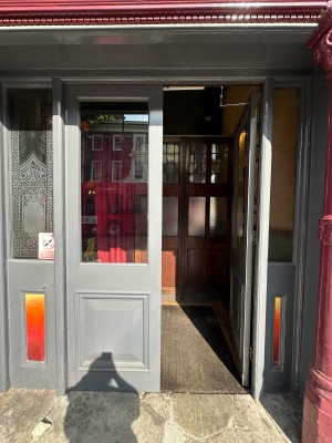 First set of grey and glass panelled doors. Push from centre to open.