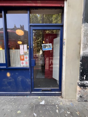 Glass door in blue frame. Pull from left to open.