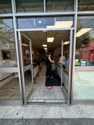 Glass doors with grey frame. Push grey handles in centre to open.