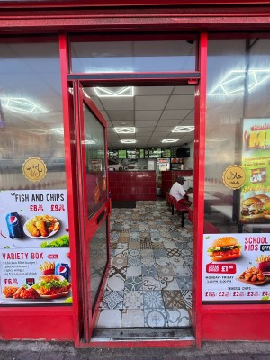 Glass door with red frames ahead. Push from right handle to open.