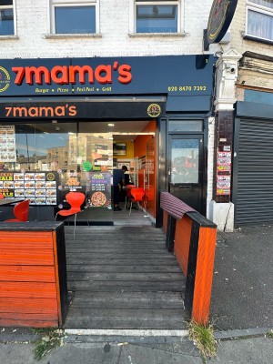 From pavement facing venue. Opening ahead. Orange dividers to left and right of it.