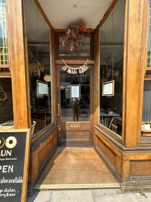 Opening followed by wood and glass panelled door. Push gold handle from left to open.