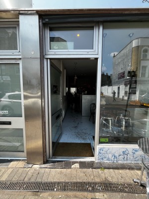Glass door with metal frame ahead. Push from right to open.